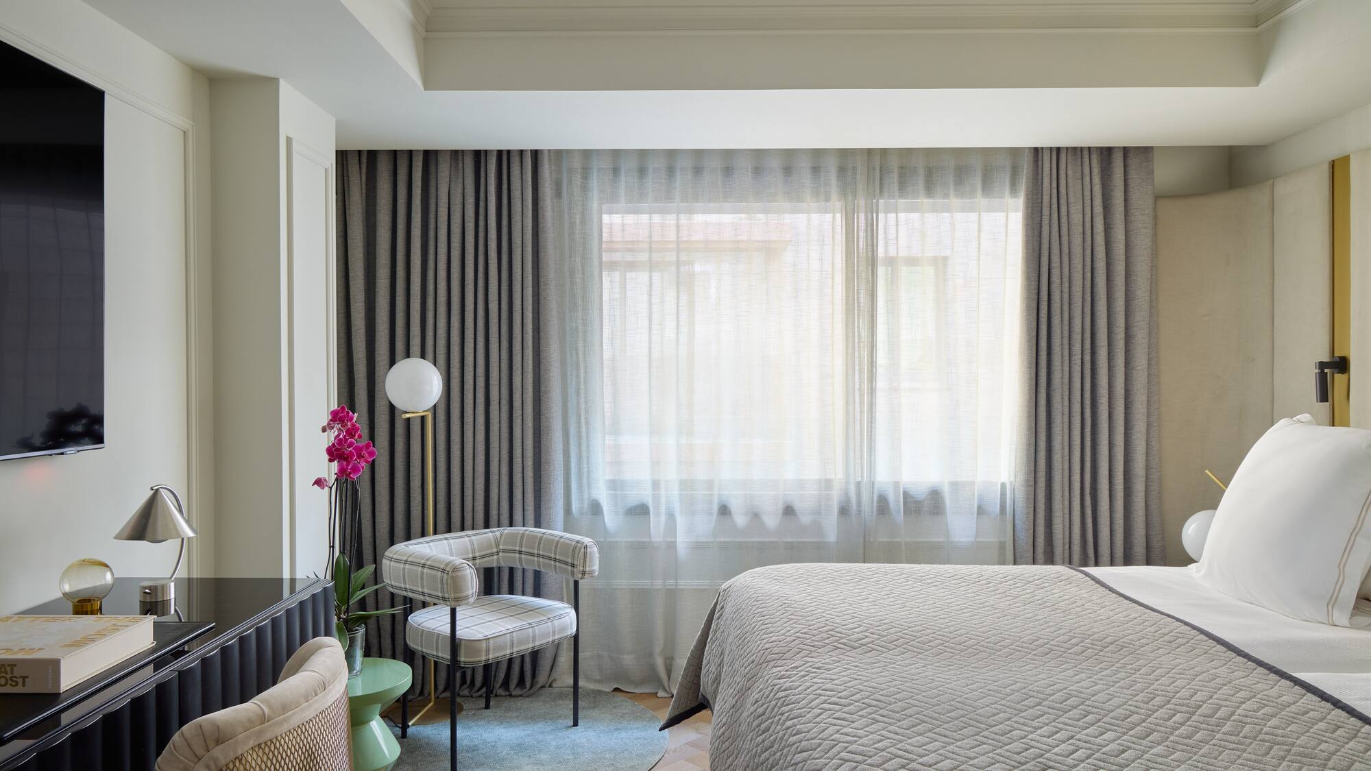 a bedroom with a bed and a chair