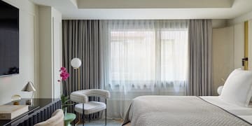 a bedroom with a bed and a chair