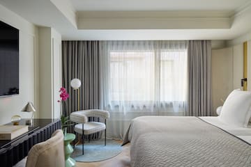 a bedroom with a bed and a chair