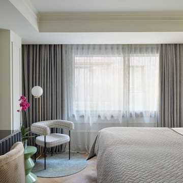 a bedroom with a bed and a chair