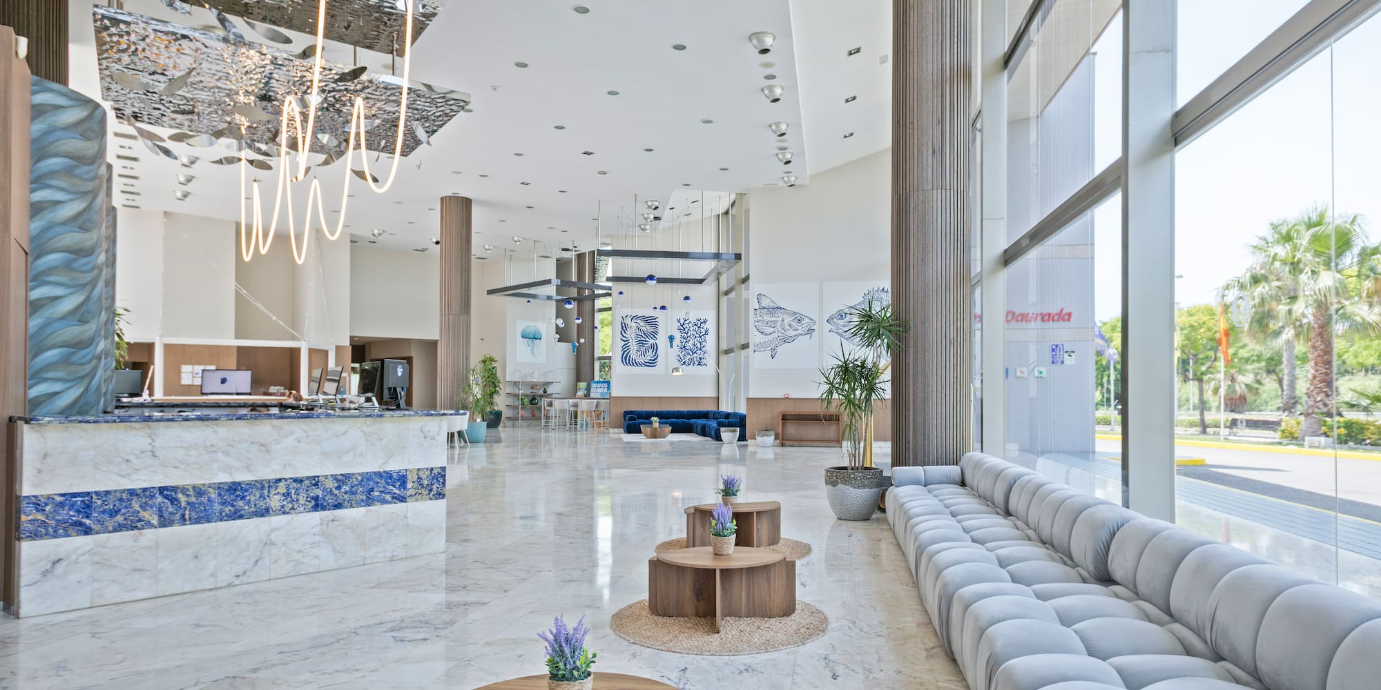 a lobby with a large couch and tables