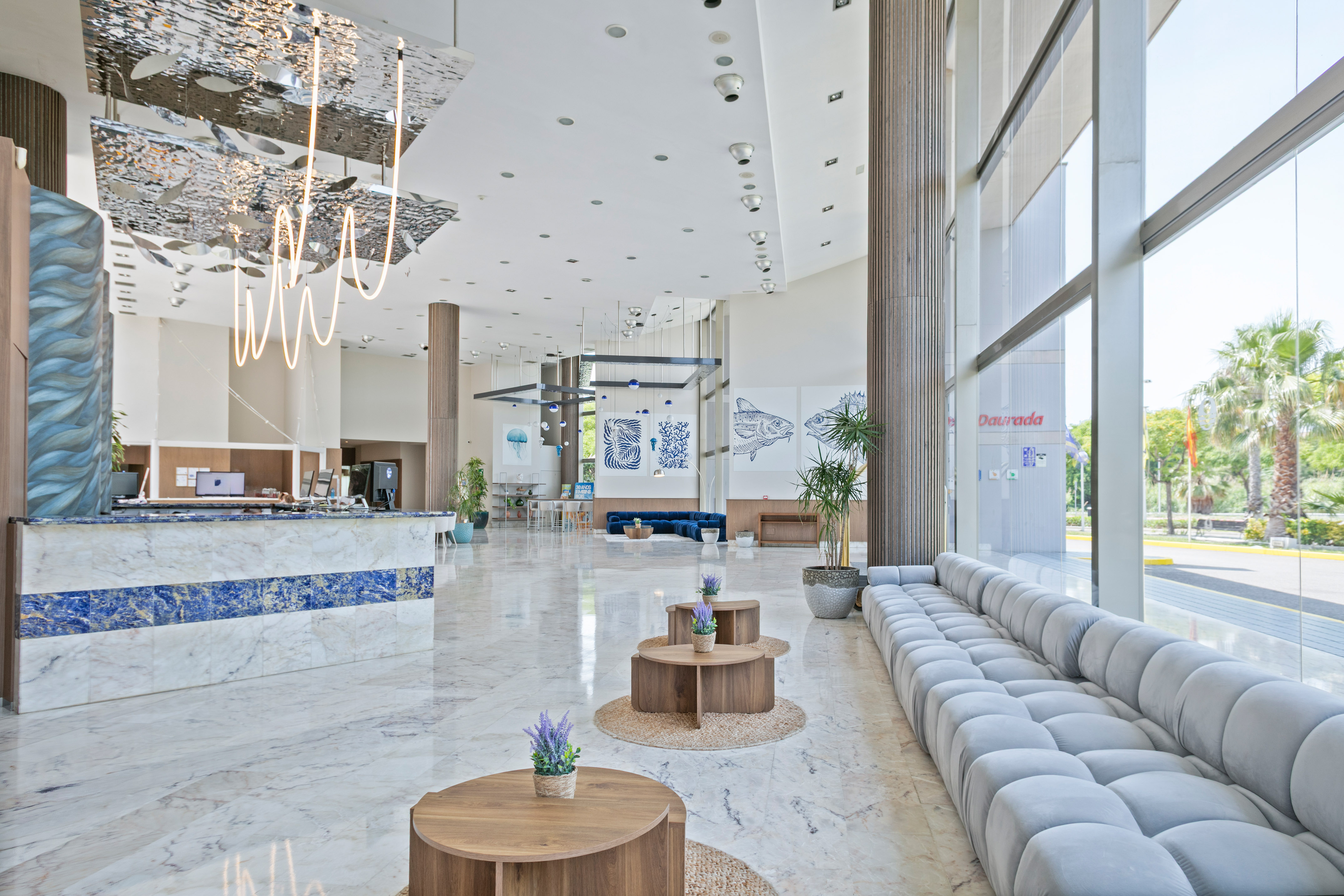 a lobby with a large couch and tables