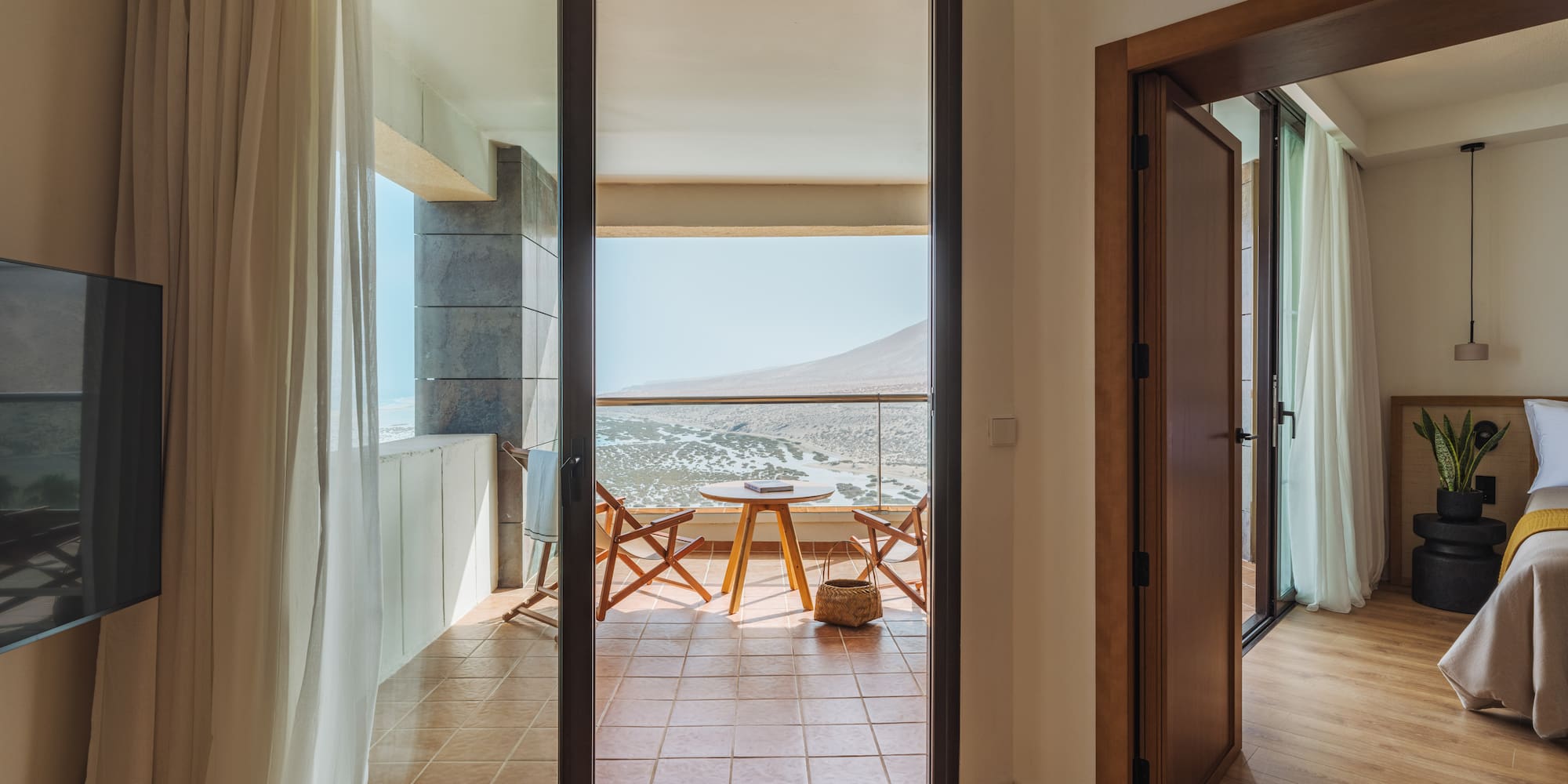 a room with a balcony and a table