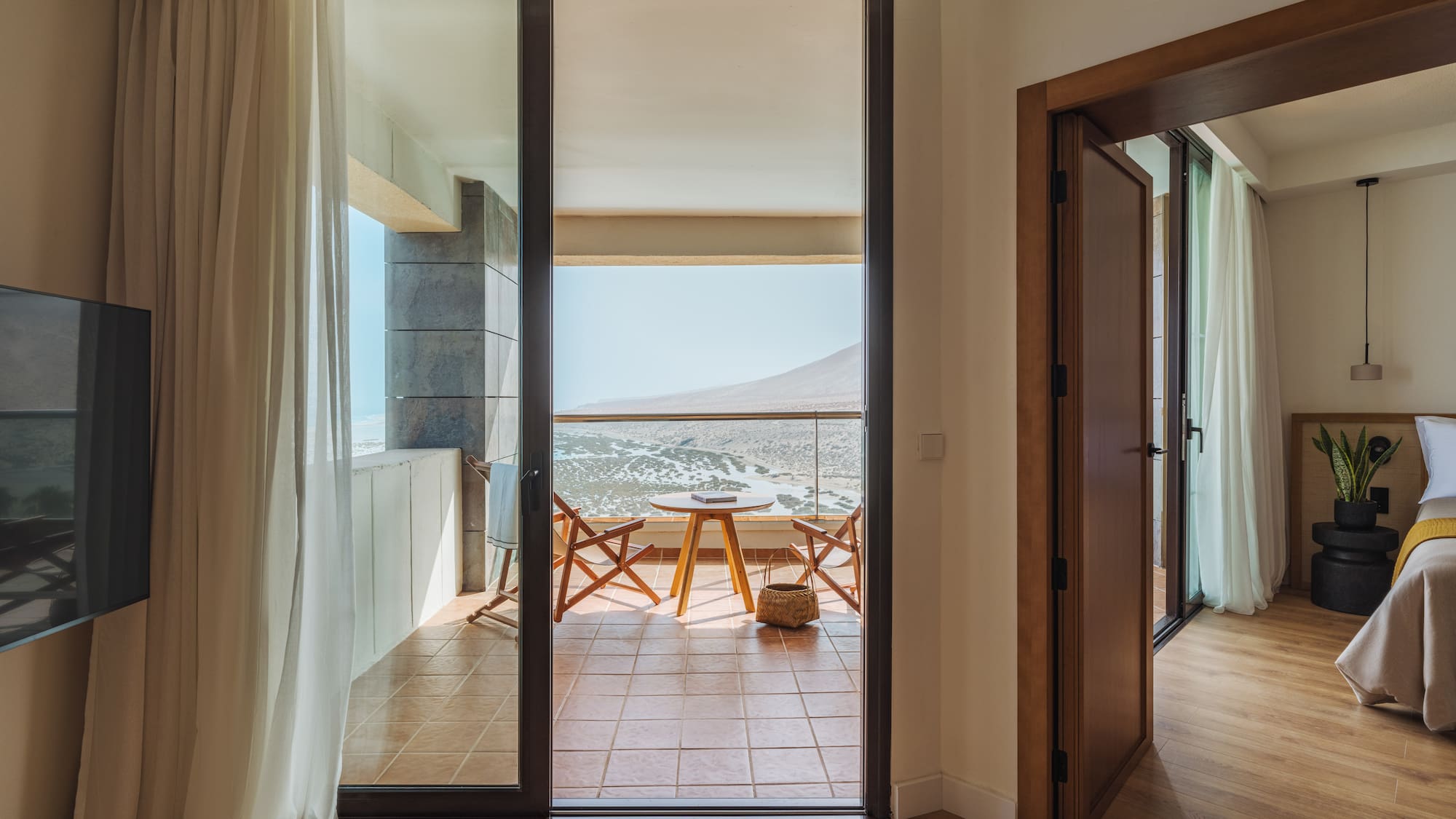 a room with a balcony and a table