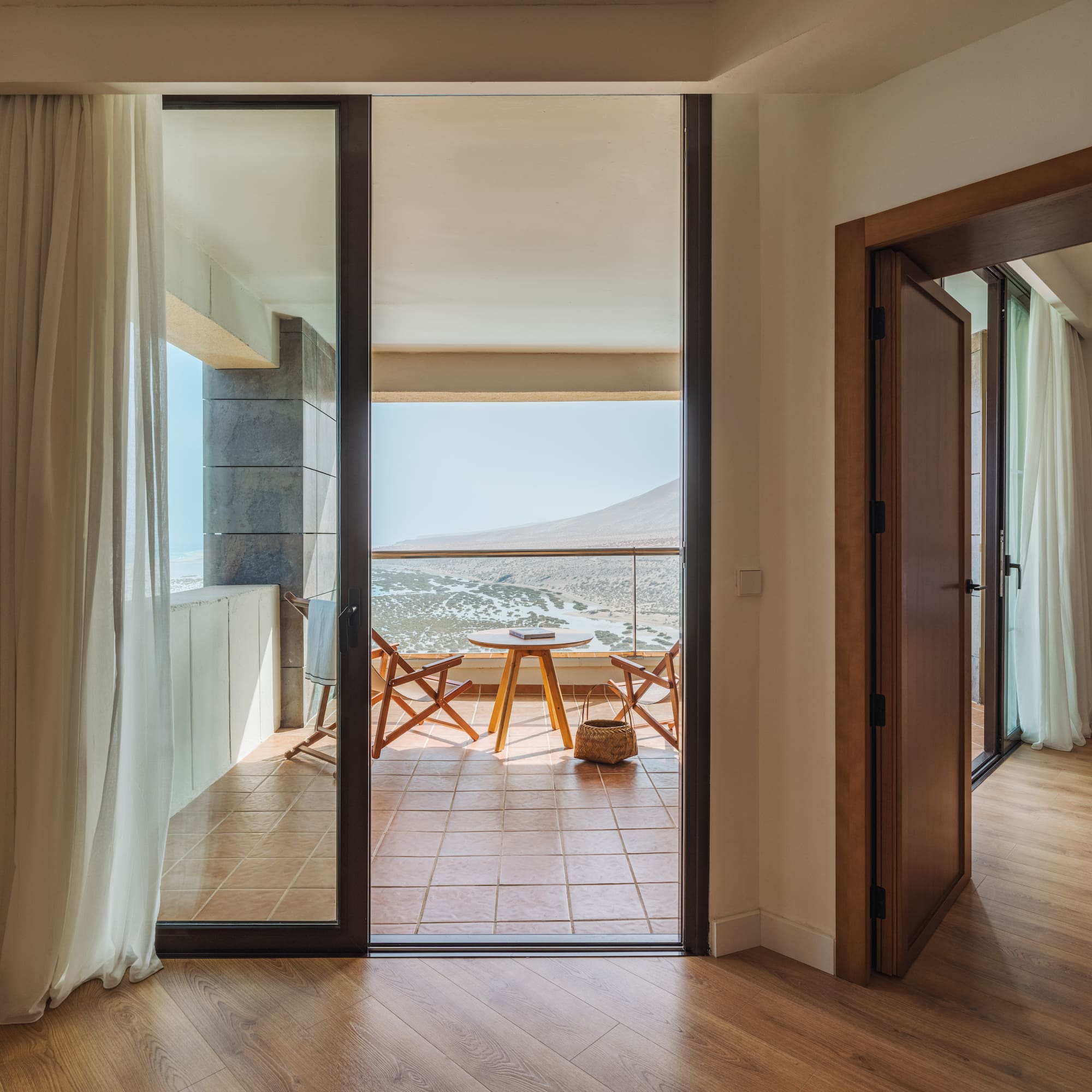 a room with a balcony and a table