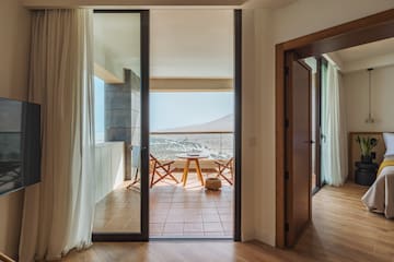 a room with a balcony and a table