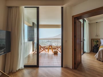 a room with a balcony and a table