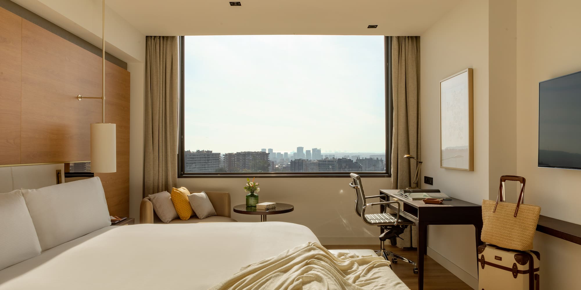 a bedroom with a large window and a bed