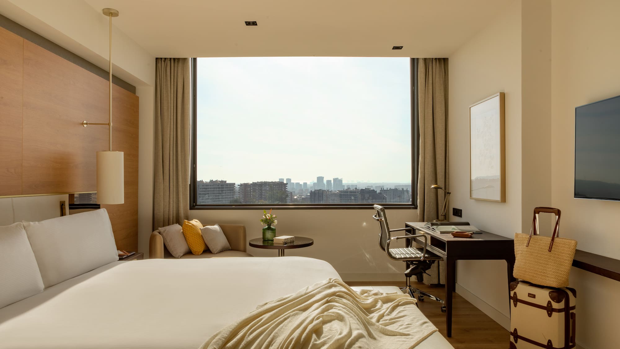 a bedroom with a large window and a bed