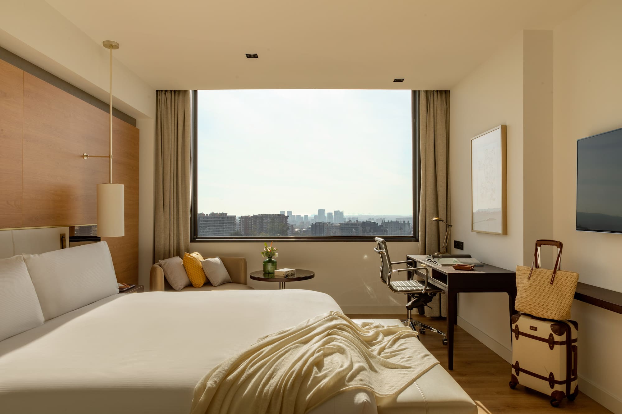 a bedroom with a large window and a bed