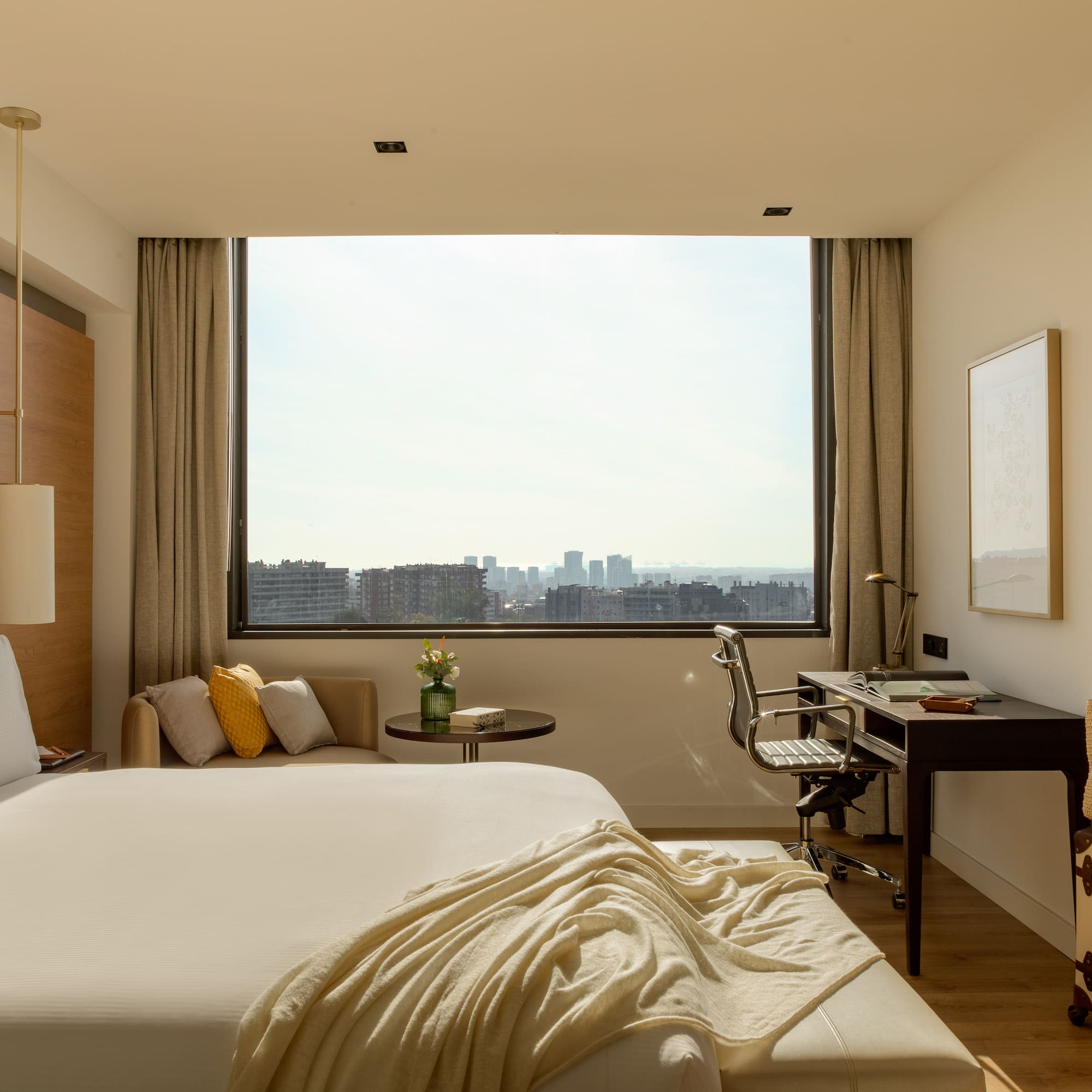 a bedroom with a large window and a bed