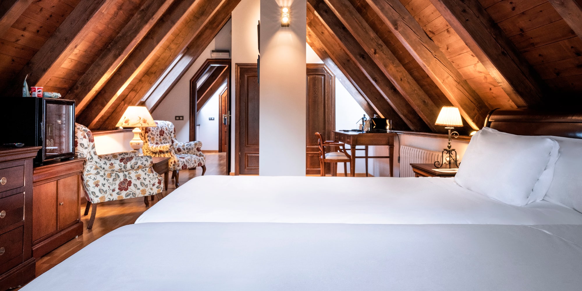 a bedroom with a wooden ceiling and a bed