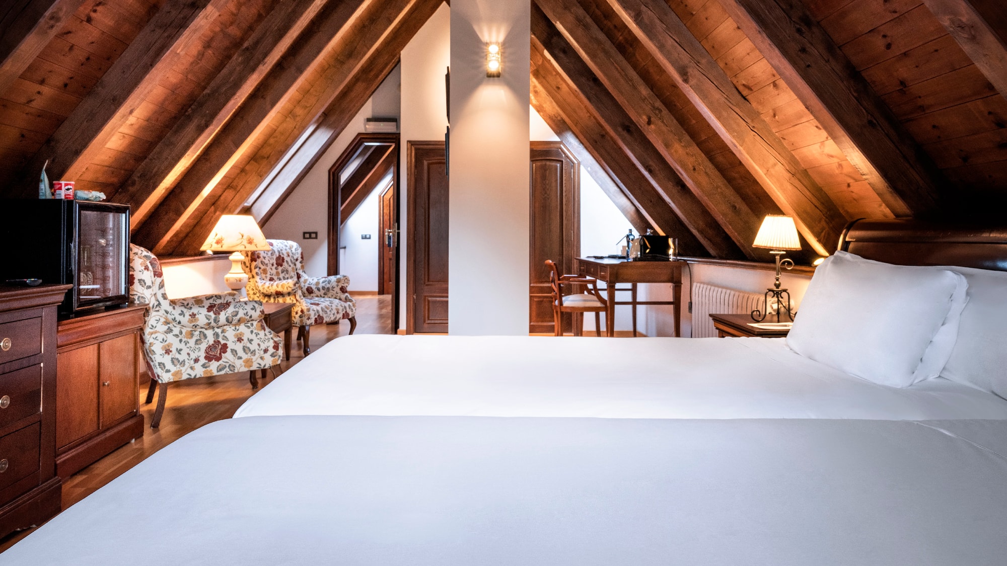 a bedroom with a wooden ceiling and a bed