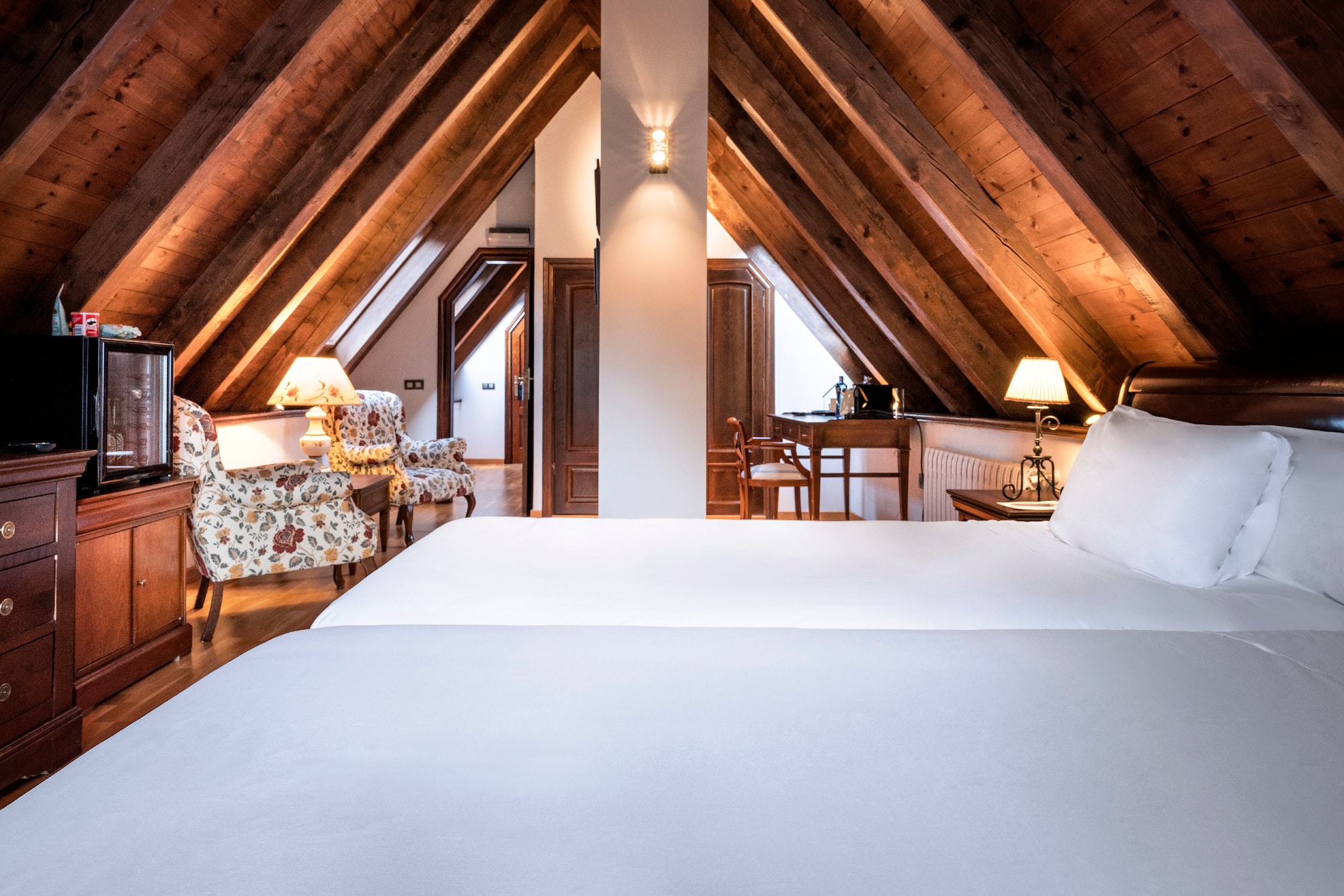 a bedroom with a wooden ceiling and a bed