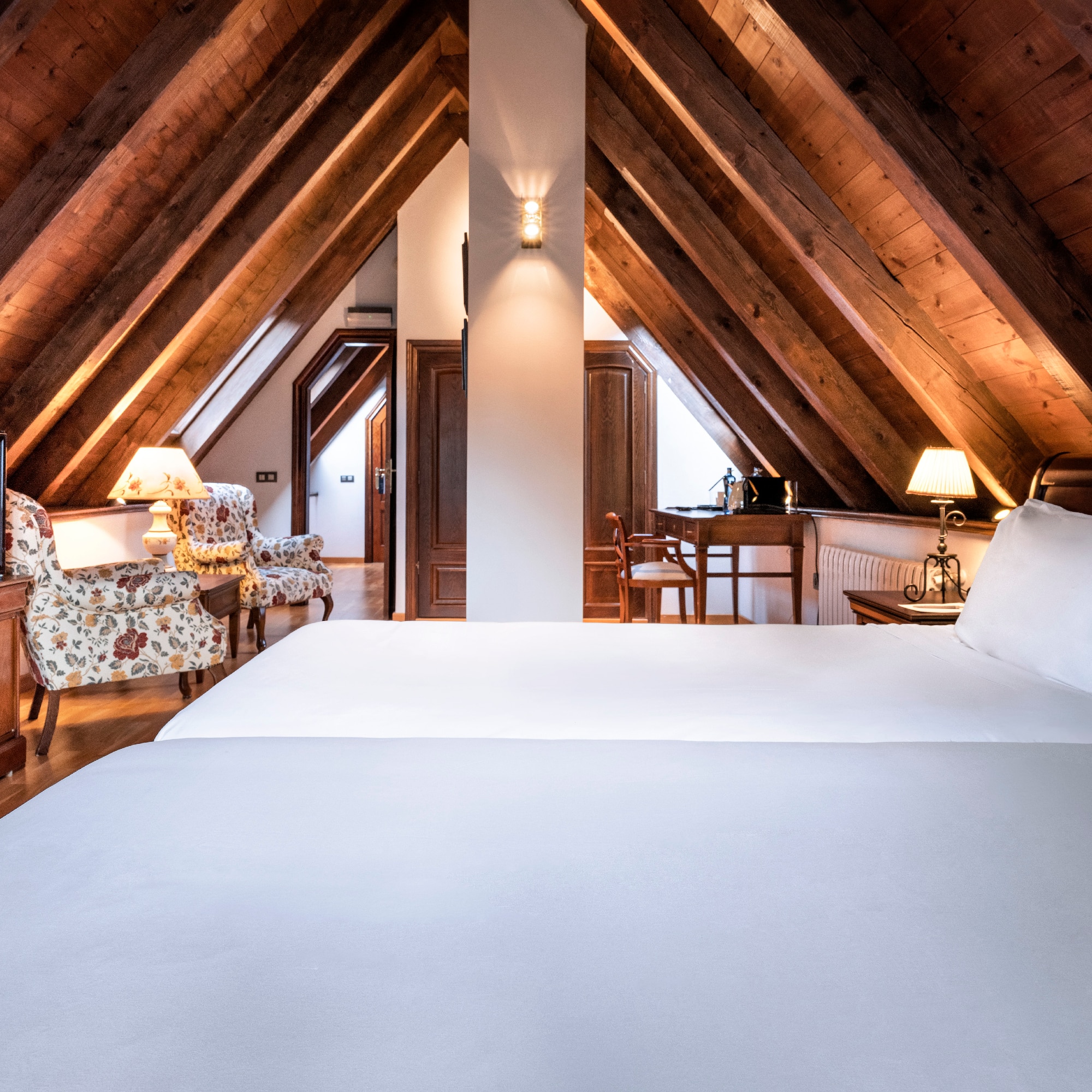 a bedroom with a wooden ceiling and a bed