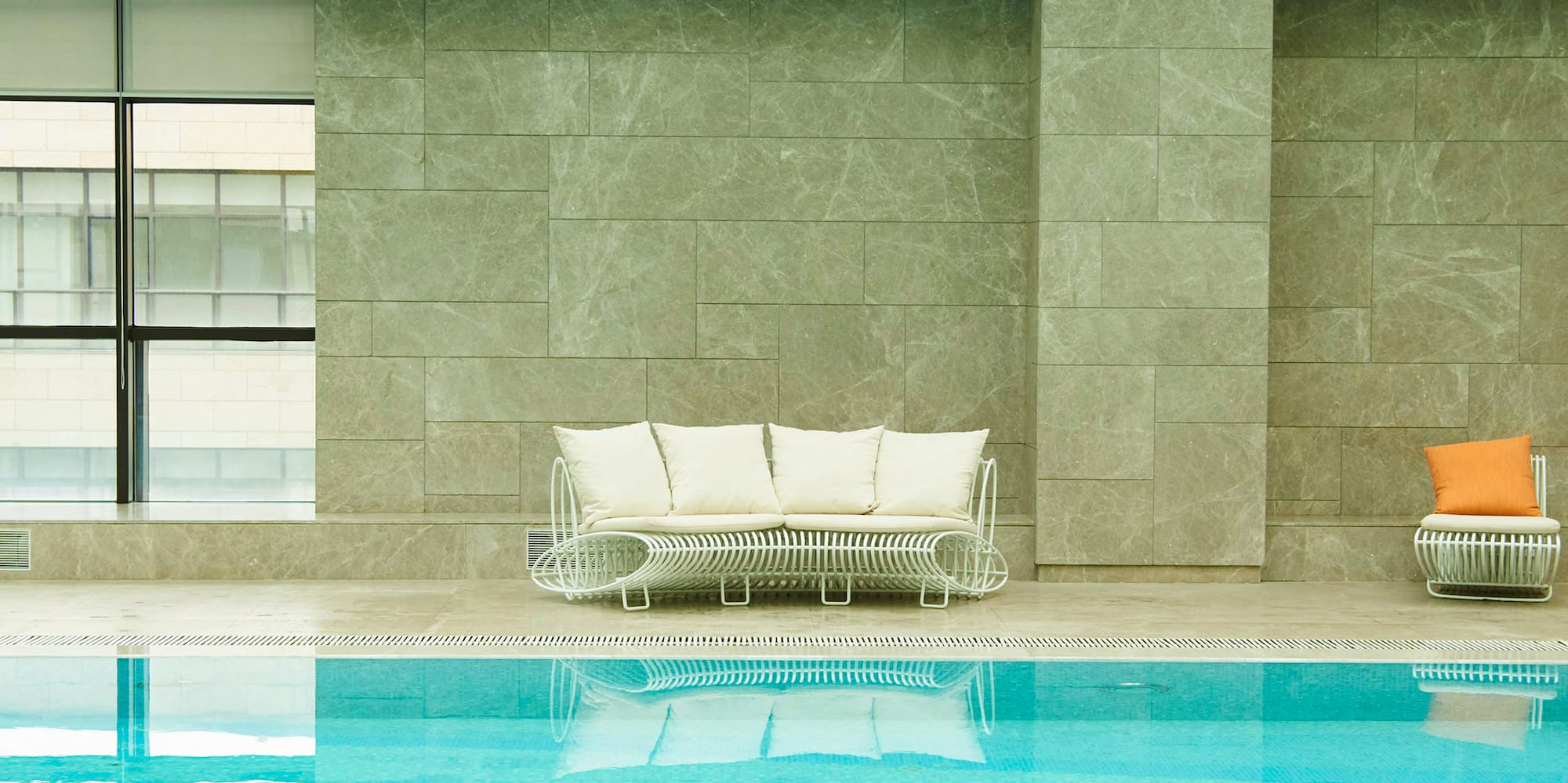 a pool with a couch and chairs