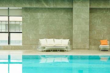 a pool with a couch and chairs