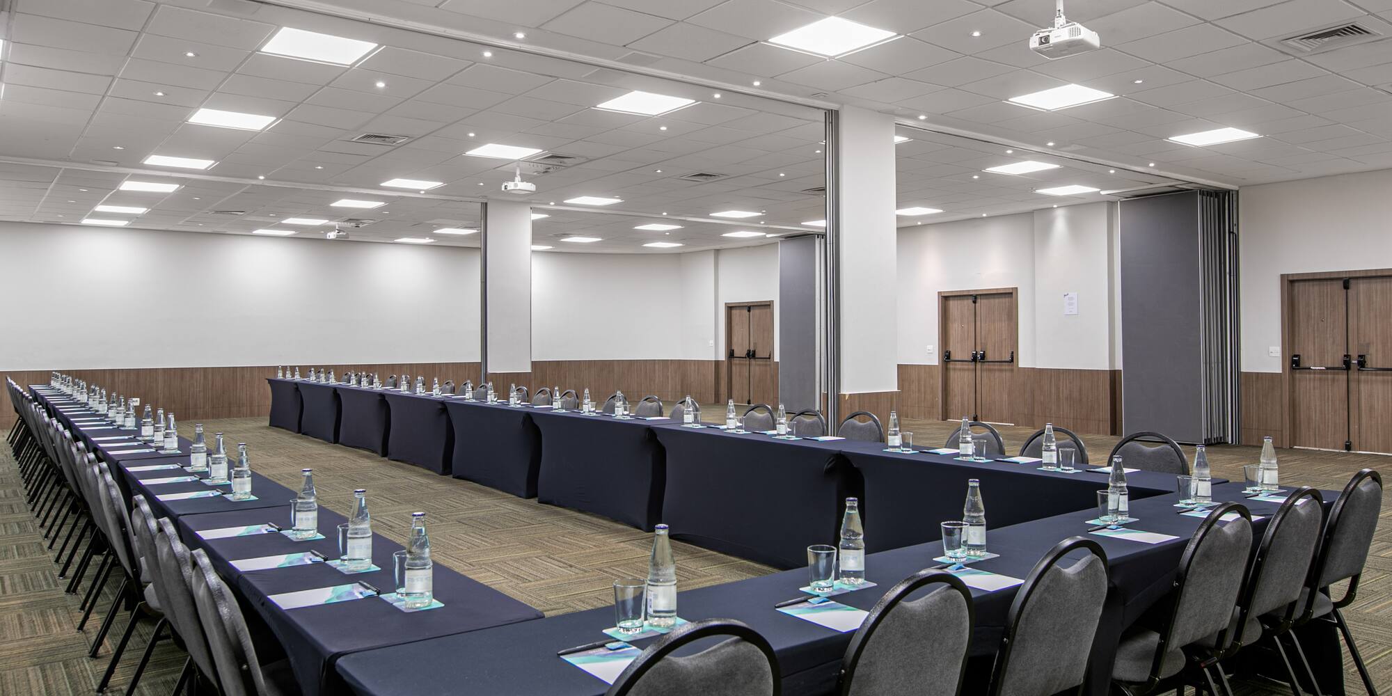 a room with long tables and chairs