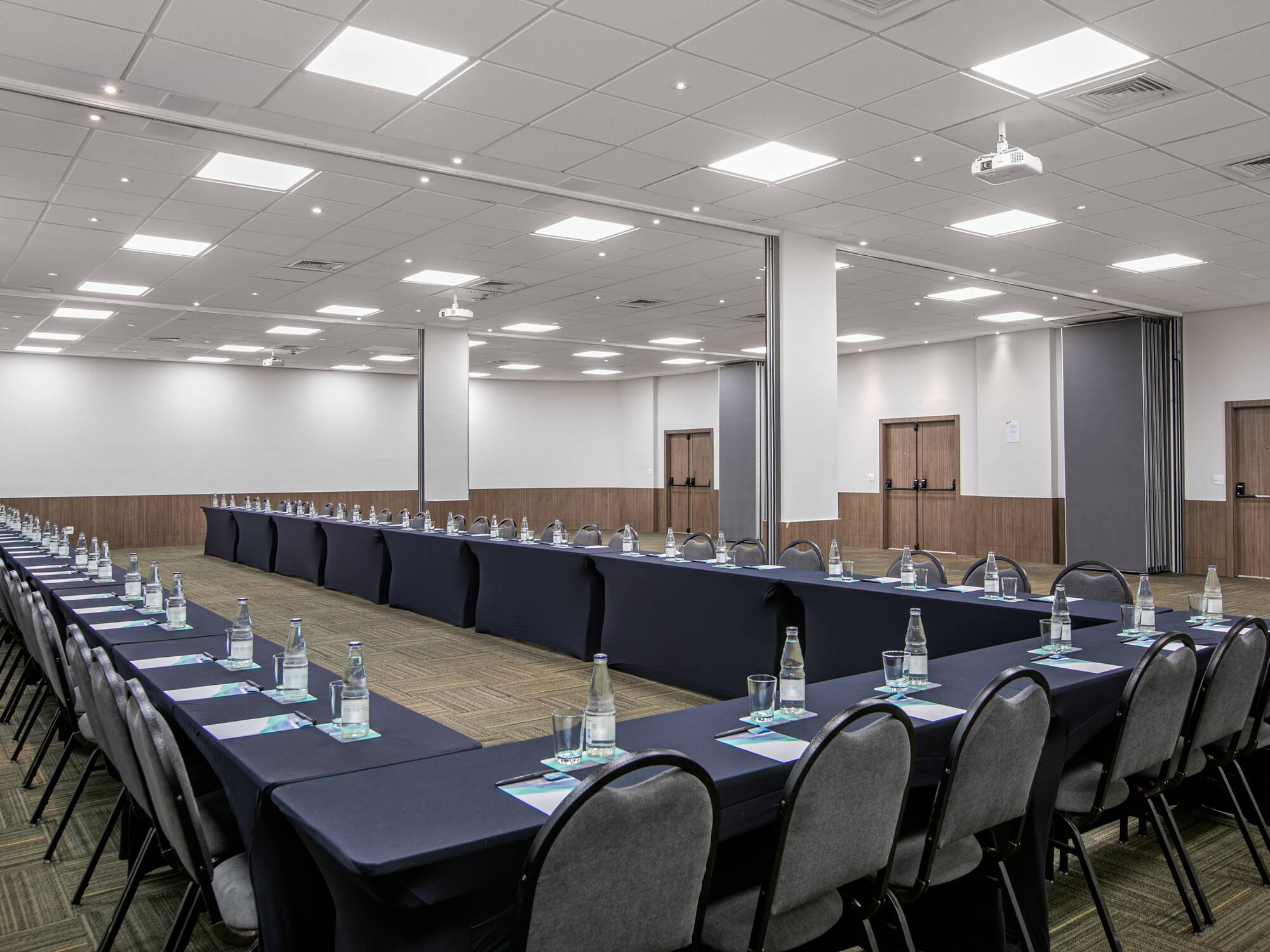 a room with long tables and chairs