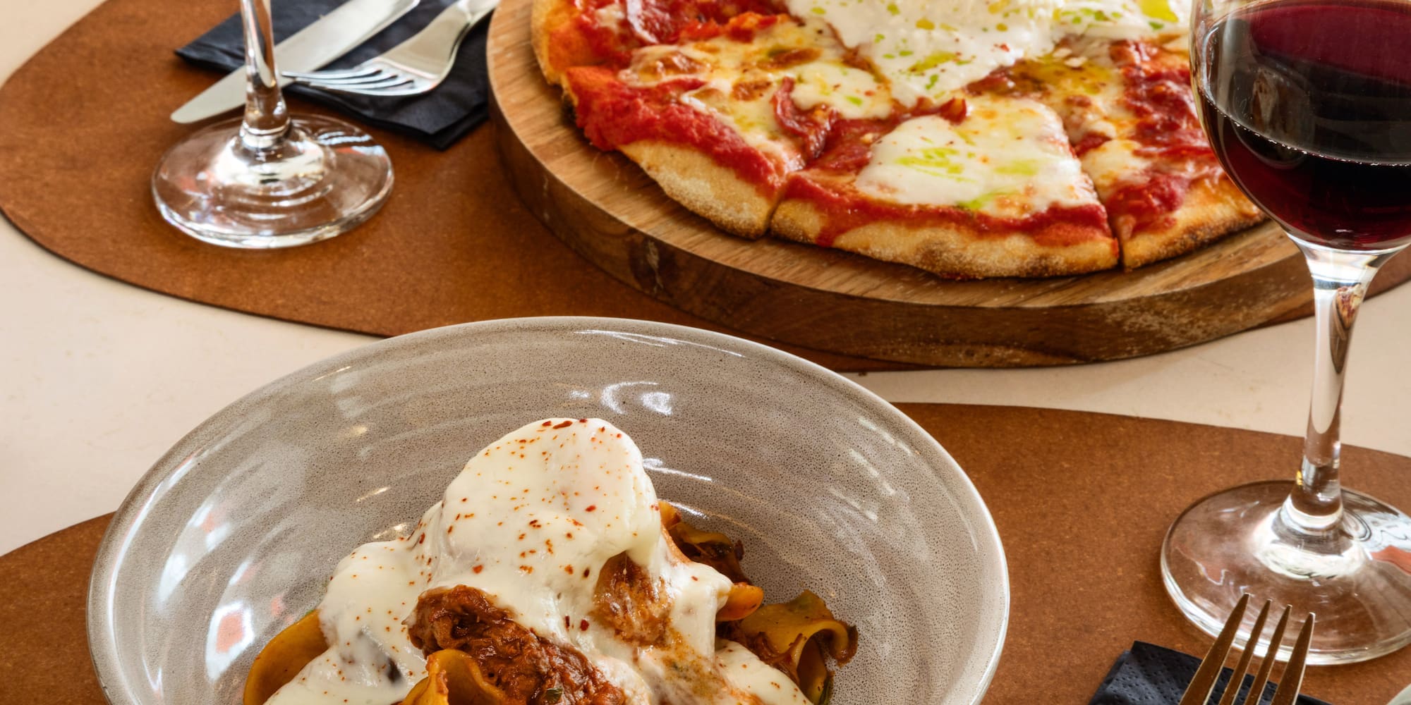 Burrata pizza, pappardelle ragu with burrata, and red wine for dinner.