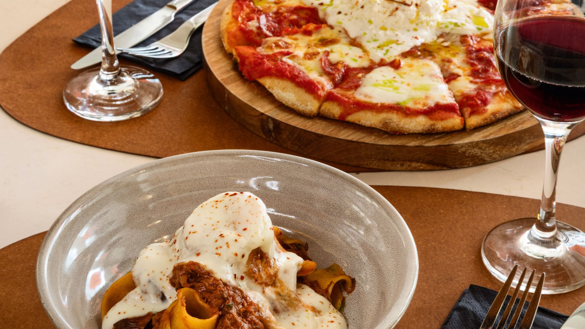 Burrata pizza, pappardelle ragu with burrata, and red wine for dinner.