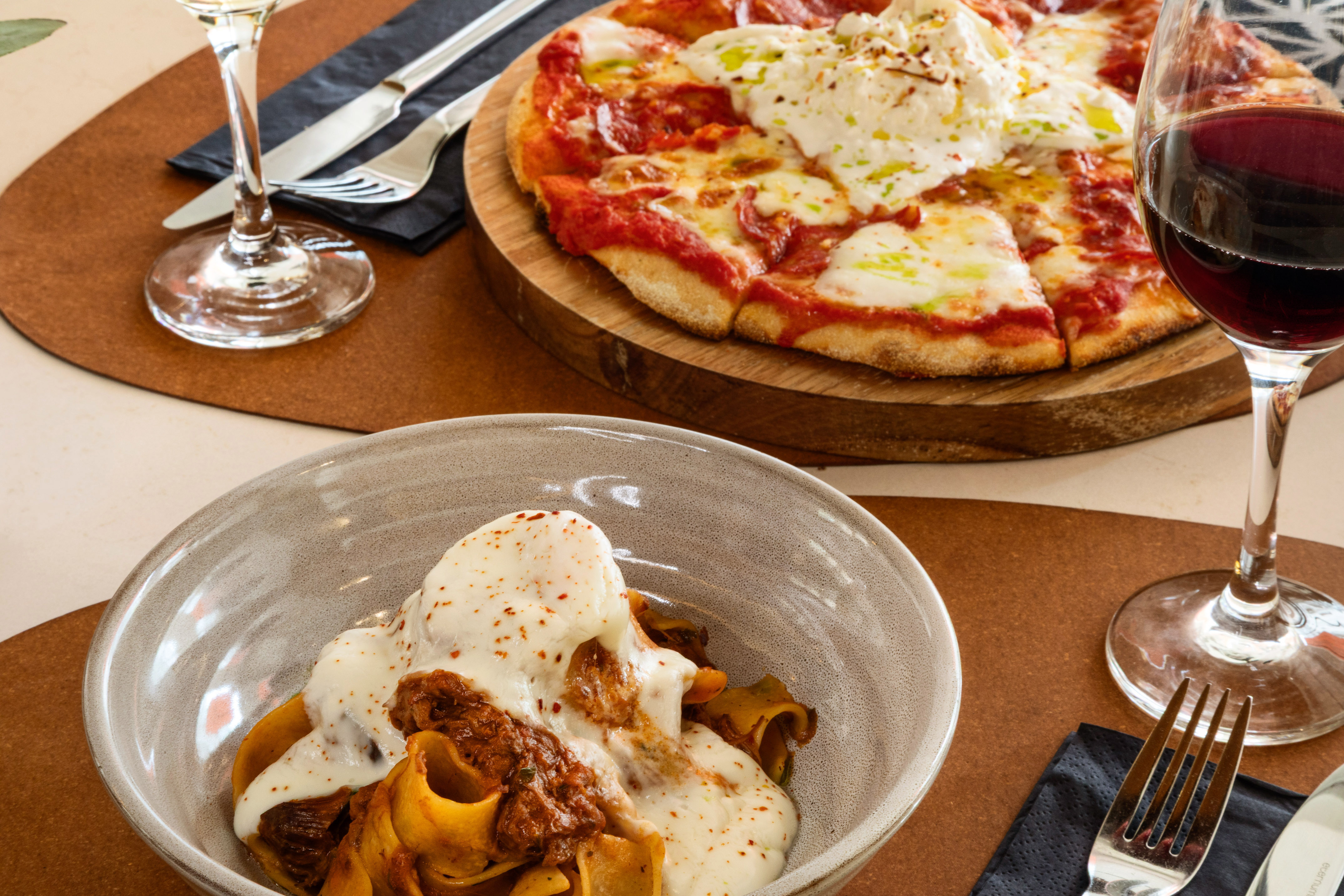 Burrata pizza, pappardelle ragu with burrata, and red wine for dinner.