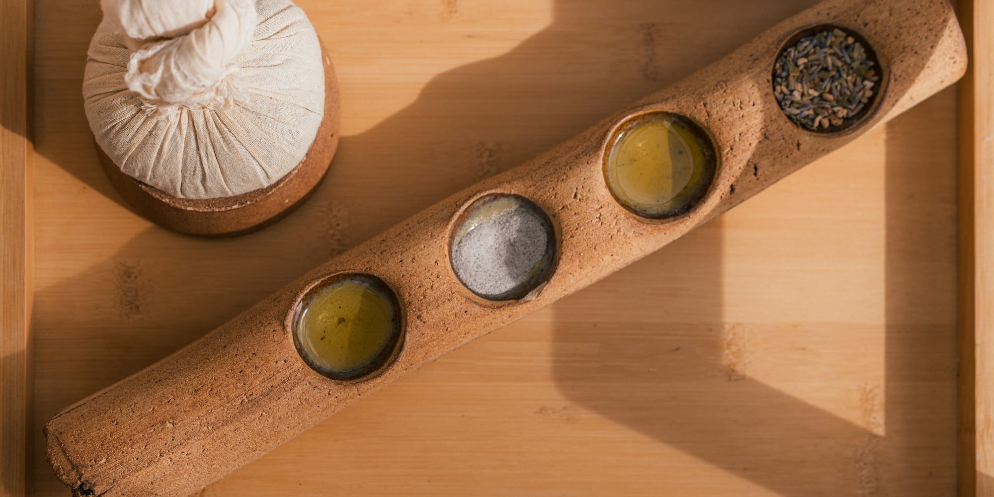 a wooden container with different spices and seeds