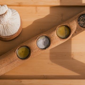 a wooden container with different spices and seeds
