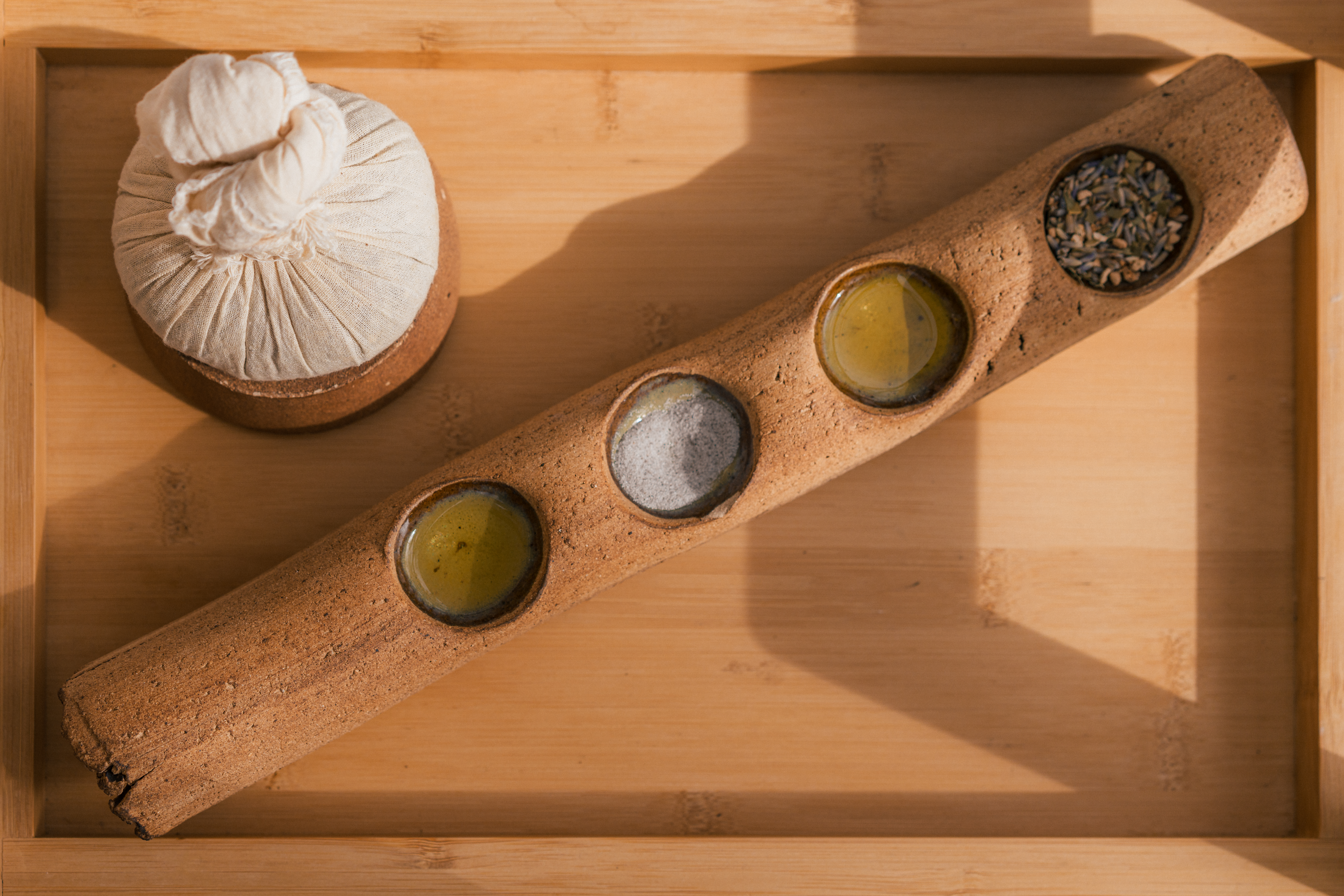 Natural spa ingredients: herbal compress, massage oils, lavender, bath salts.