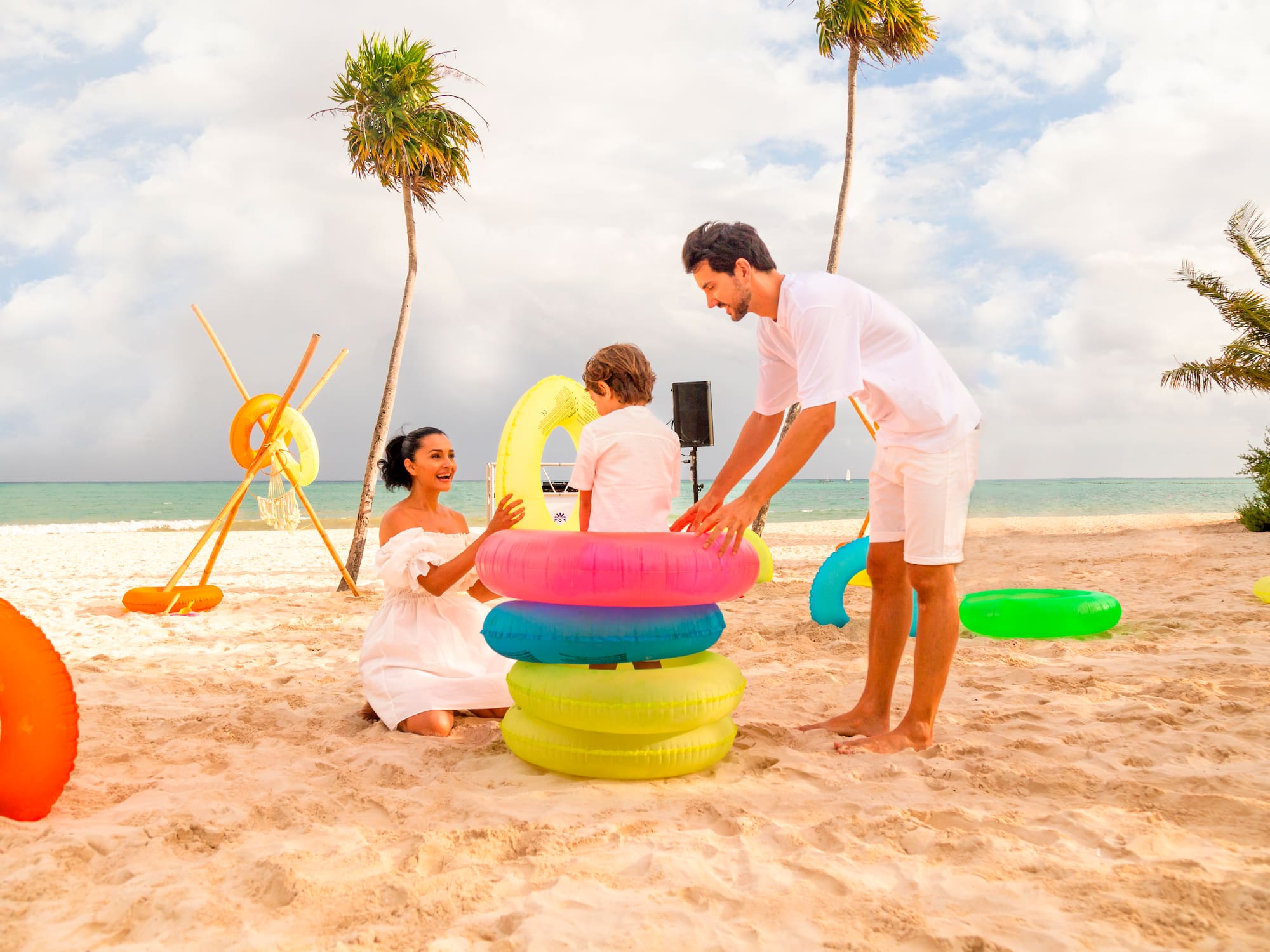 a man and woman with a child on a beach