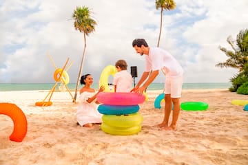 a man and woman with a child on a beach