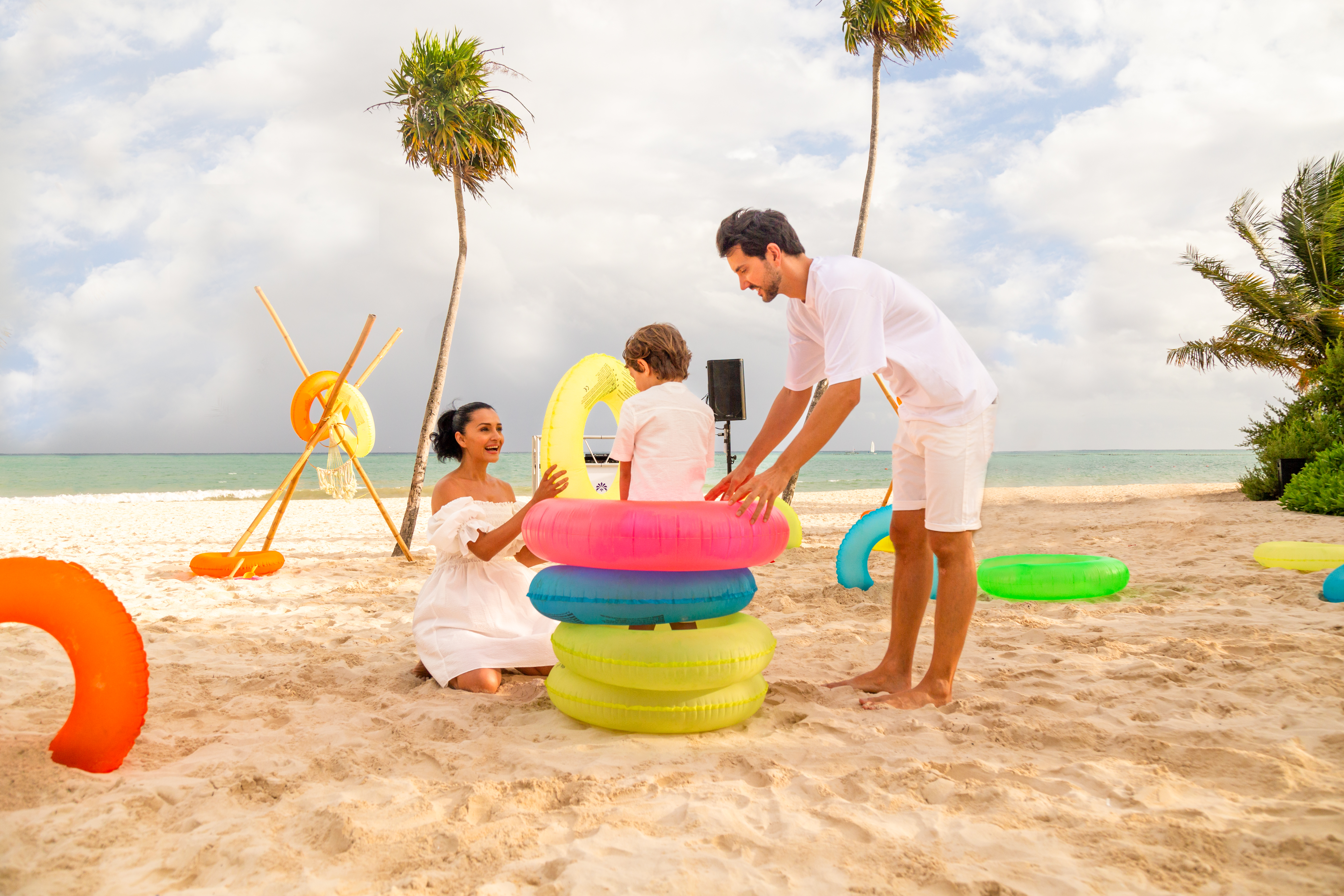 a man and woman with a child on a beach