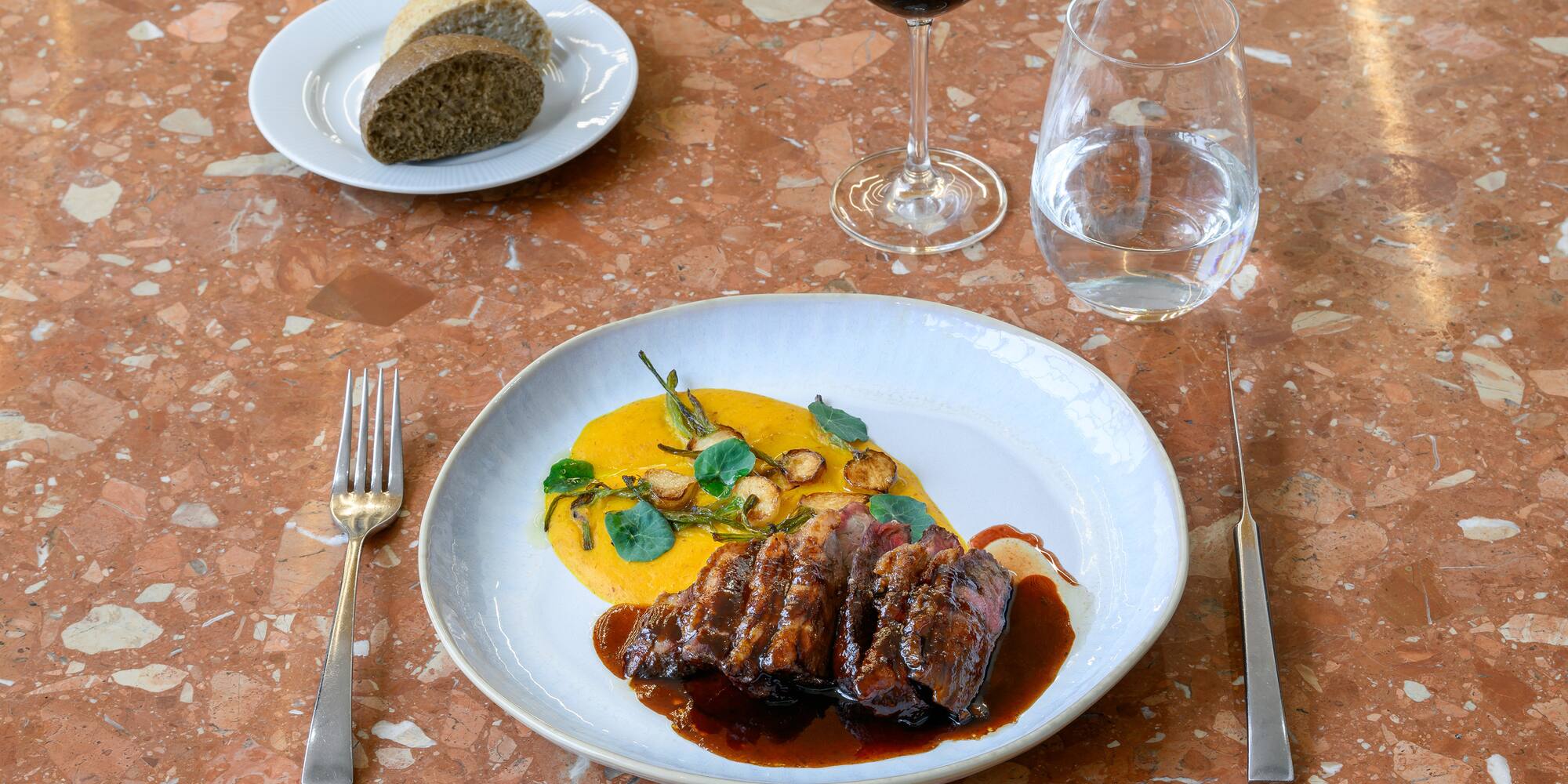 a plate of food and a glass of wine