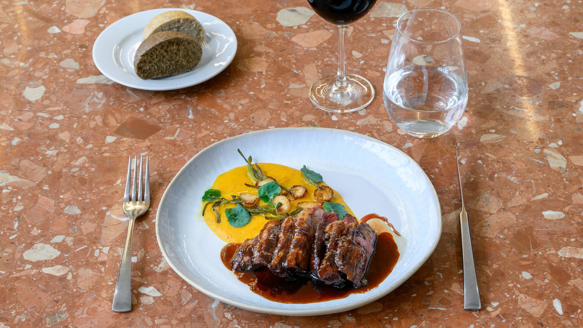 a plate of food and a glass of wine