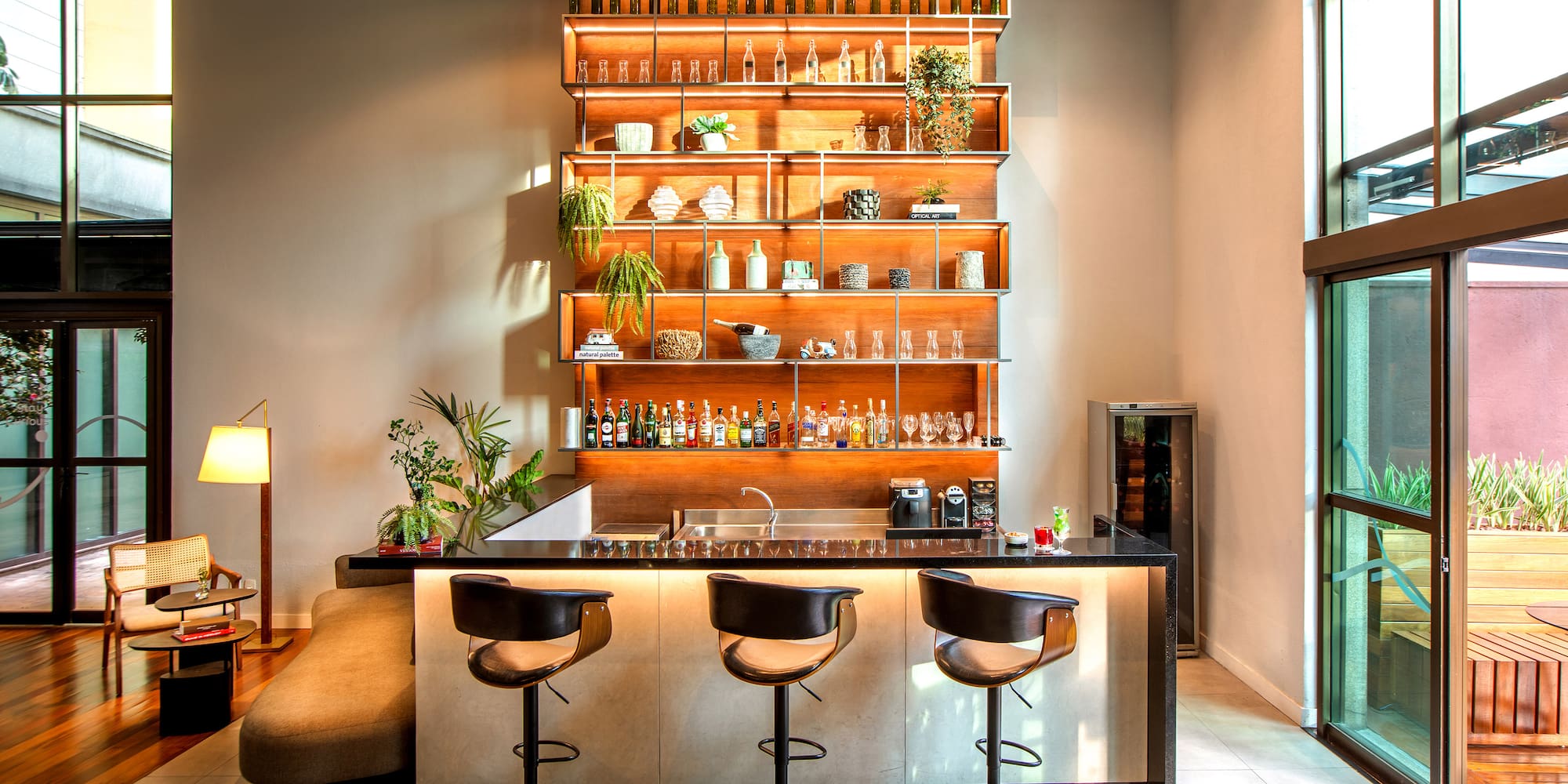 a bar with shelves and bottles on the wall