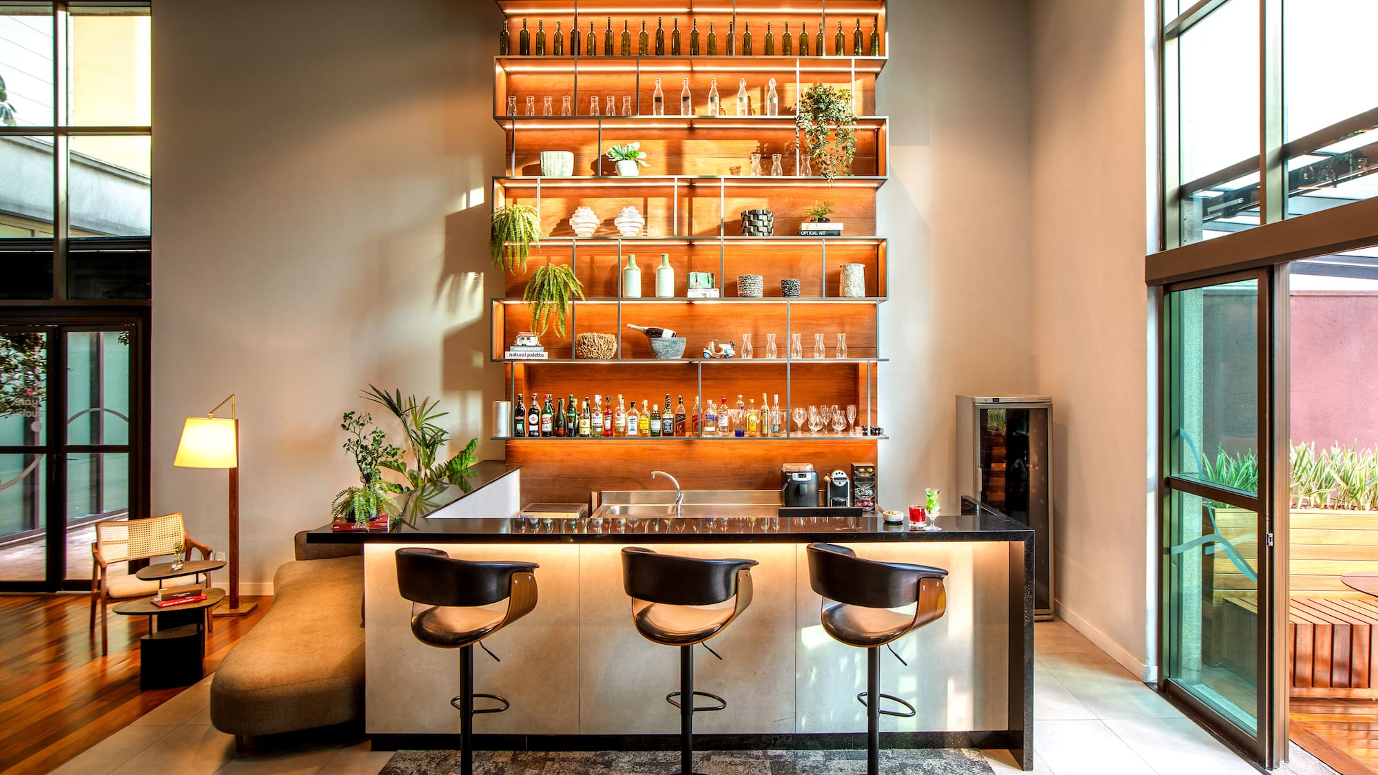 a bar with shelves and bottles on the wall