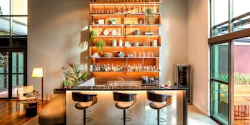 a bar with shelves and bottles on the wall