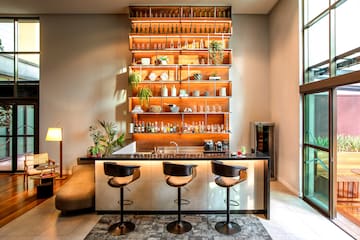a bar with shelves and bottles on the wall