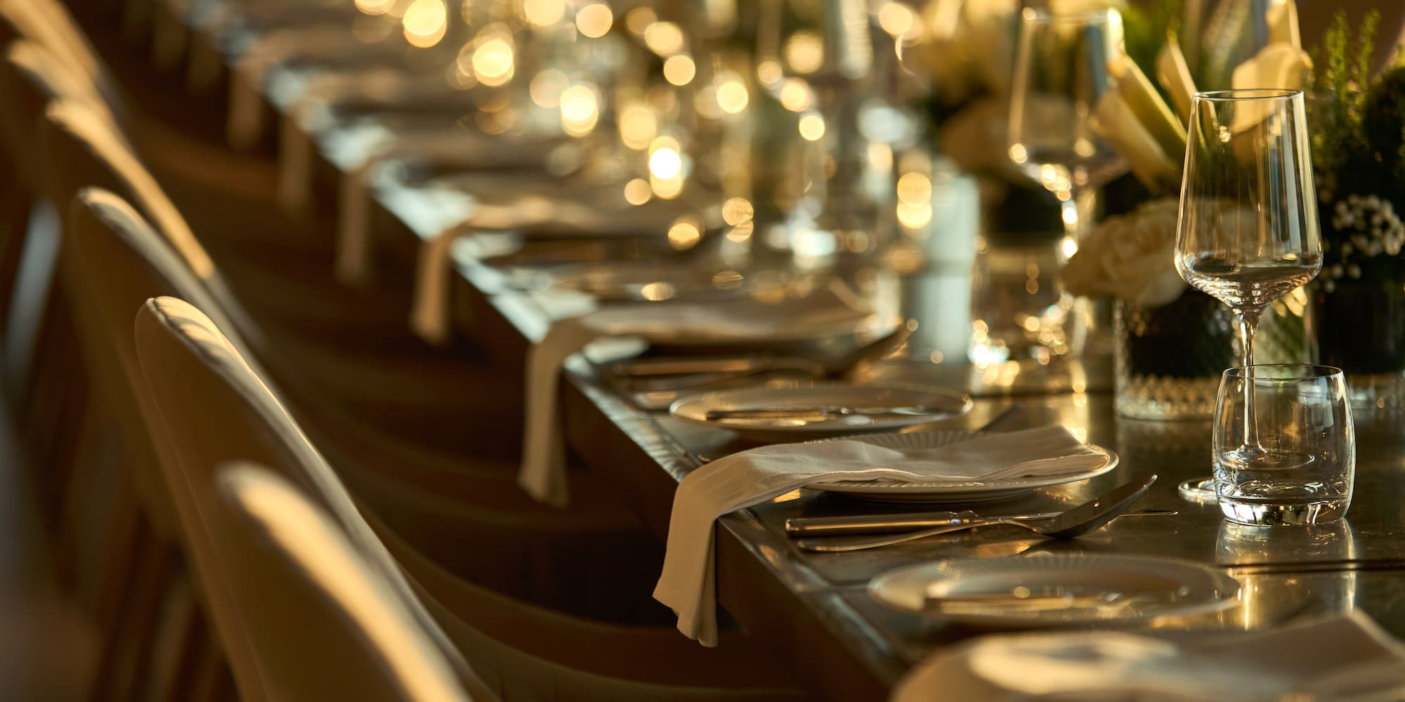 a long table with plates and glasses