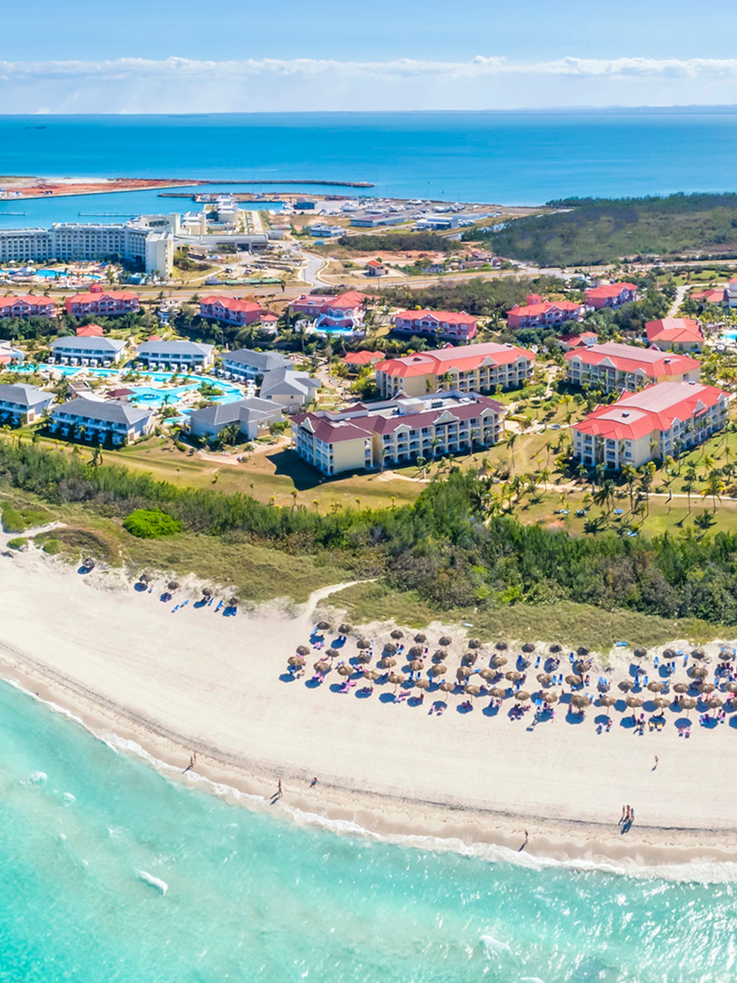 a beach with buildings and a body of water