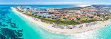 a beach with buildings and a body of water