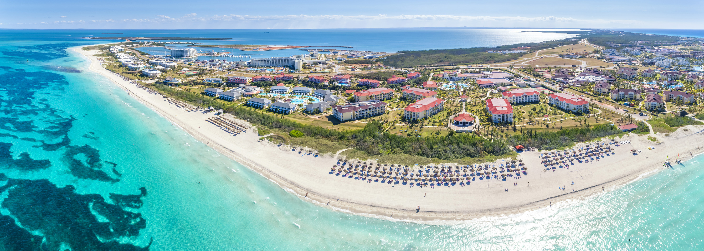 a beach with buildings and a body of water