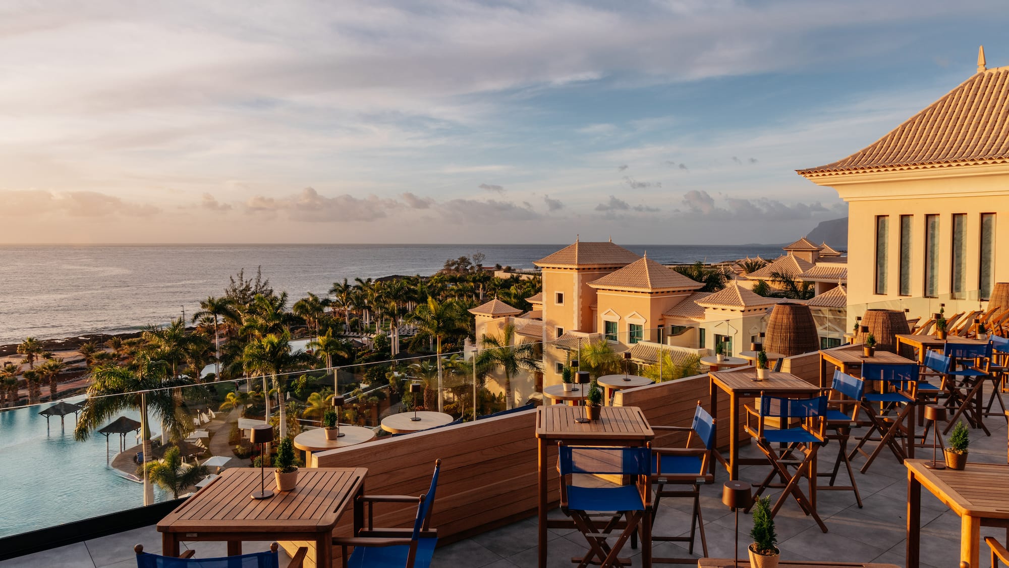 a restaurant with tables and chairs overlooking a body of water