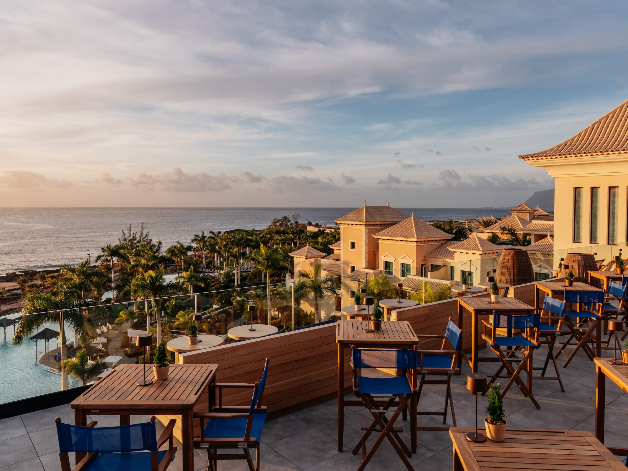 a restaurant with tables and chairs overlooking a body of water