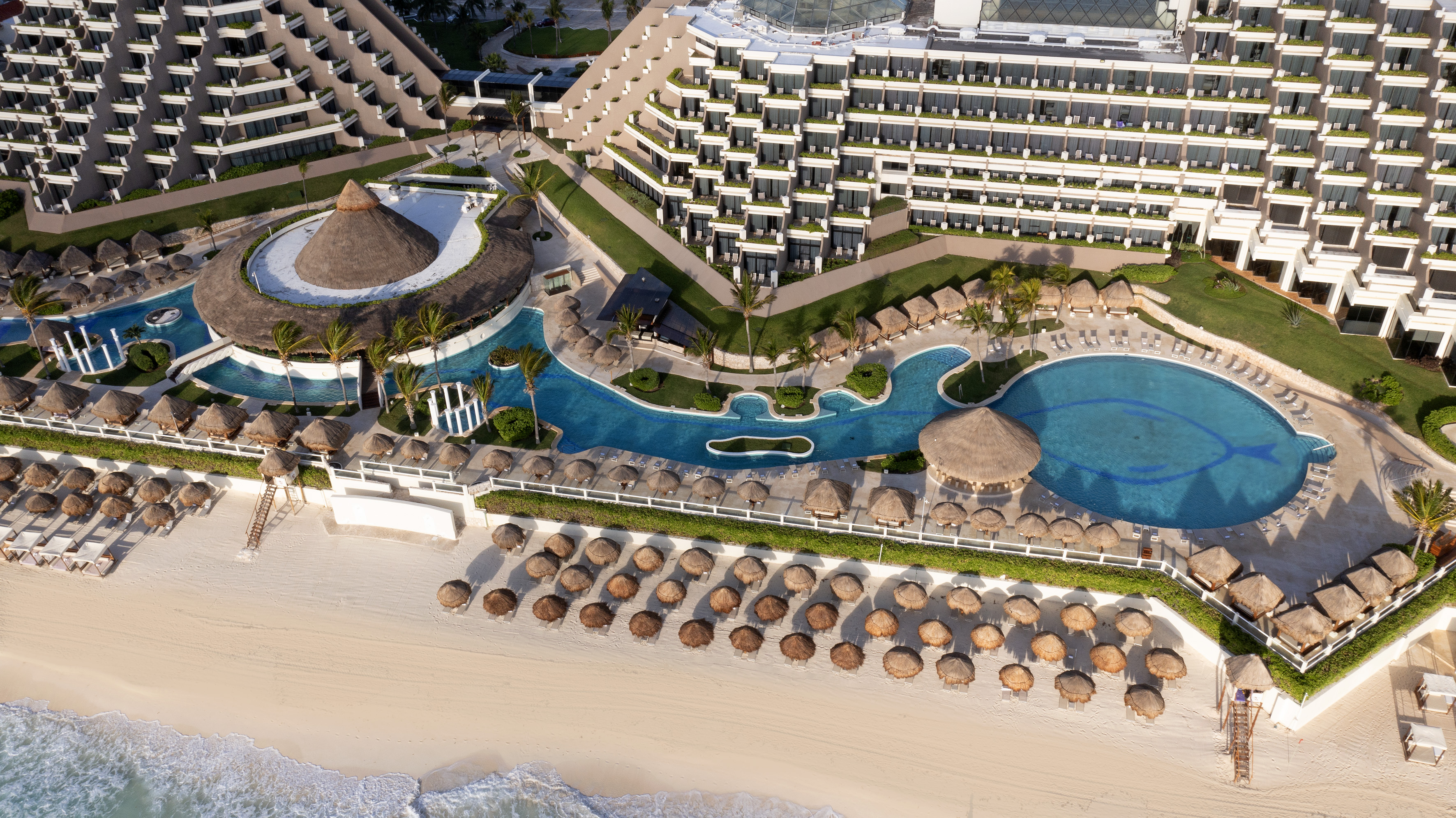 a resort with a pool and a beach