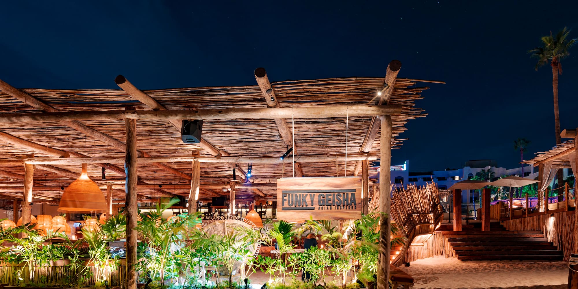 a wooden structure with plants and lights