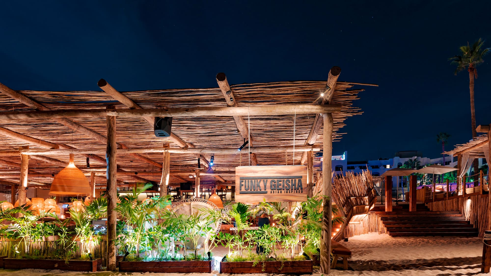 a wooden structure with plants and lights