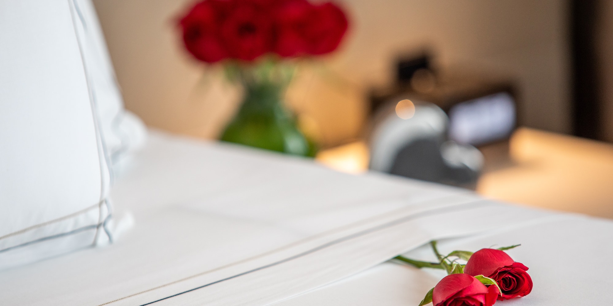 a bouquet of roses on a bed