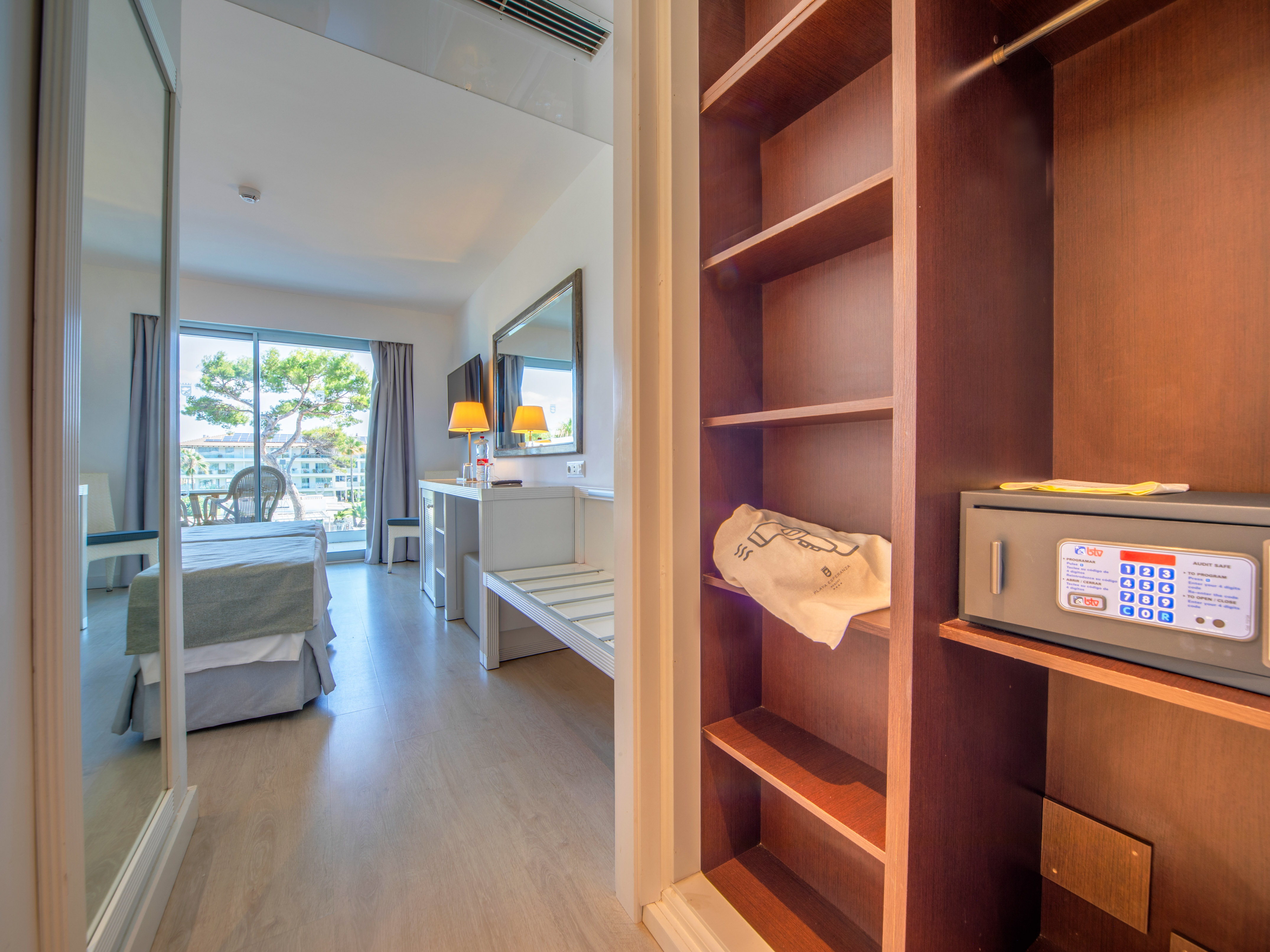 a room with a bed and a bookcase