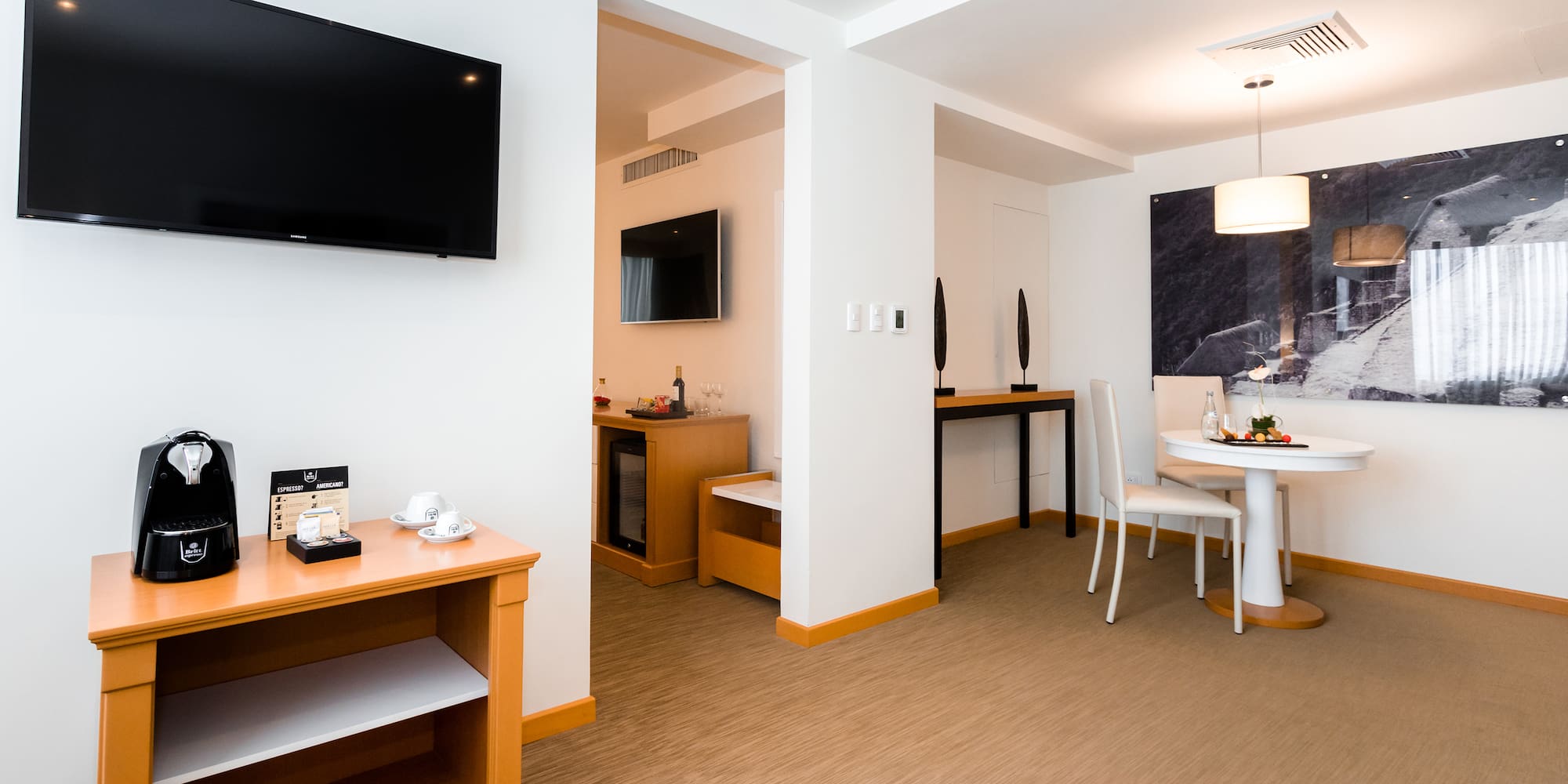 a room with a table and chairs and a television